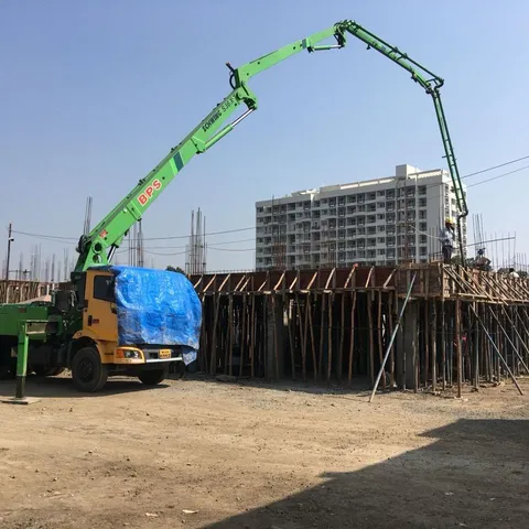 Concrete boom pump placing concrete on a slab